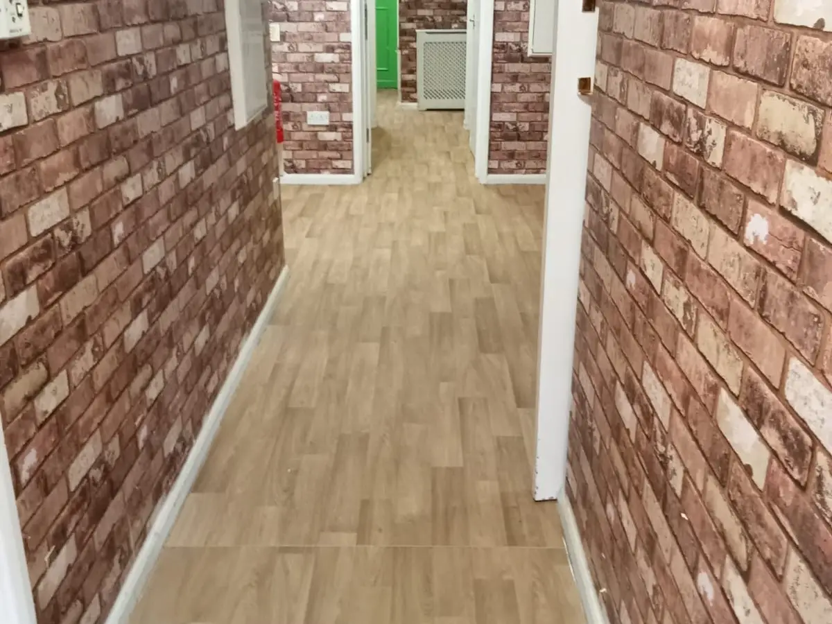 Image of safety flooring in a nursing home, featuring slip-resistant surfaces designed to prevent falls and enhance mobility for elderly residents. The flooring is made of durable, easy-to-clean materials and is installed in a well-lit corridor to promote safety and comfort.